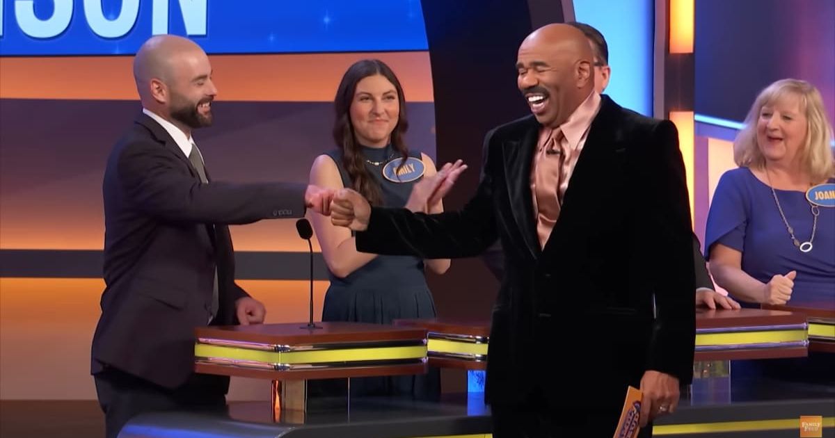 Screenshot showing Steve Harvey fist bumping a player for his answer (Cover image source: YouTube/Family Feud)