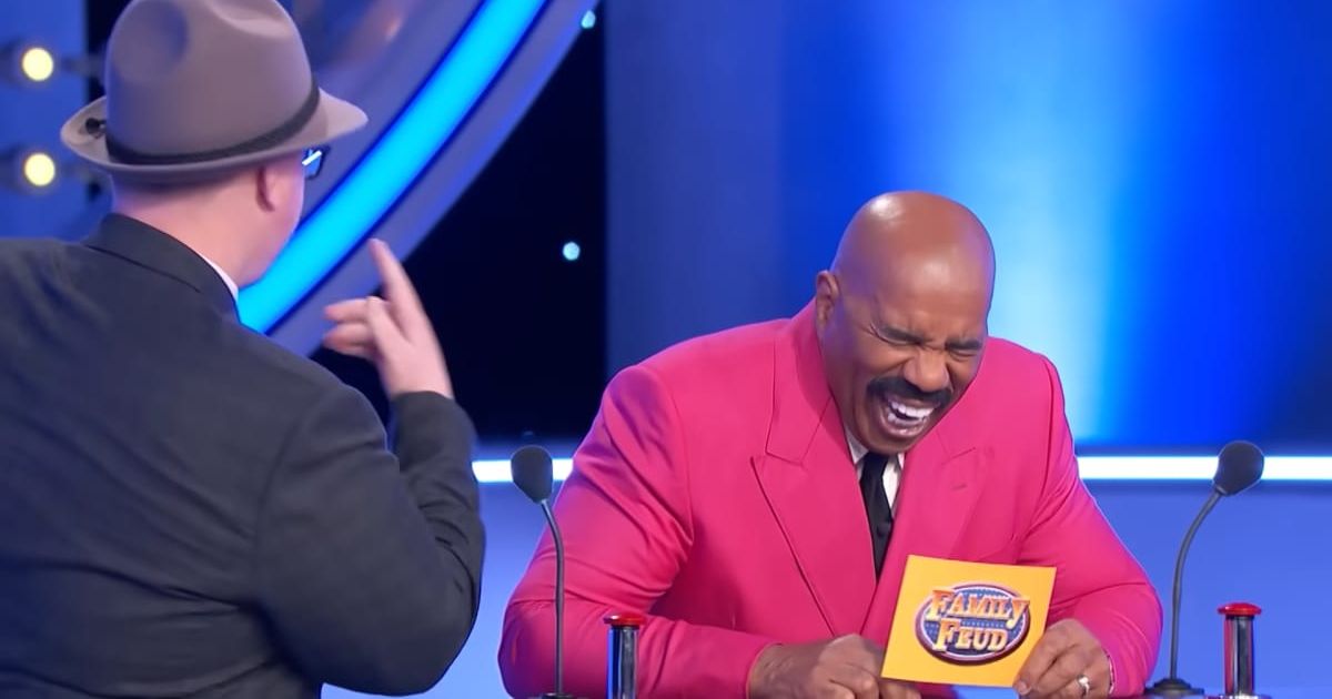 Screenshot showing Steve Harvey laughing his heart out at the podium (Cover image source: YouTube/Family Feud)