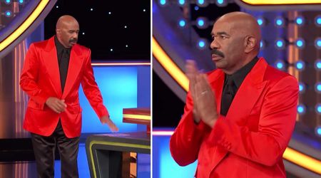 'Family Feud' host Steve Harvey puts down his cards to clap for a contestant's impressive answer