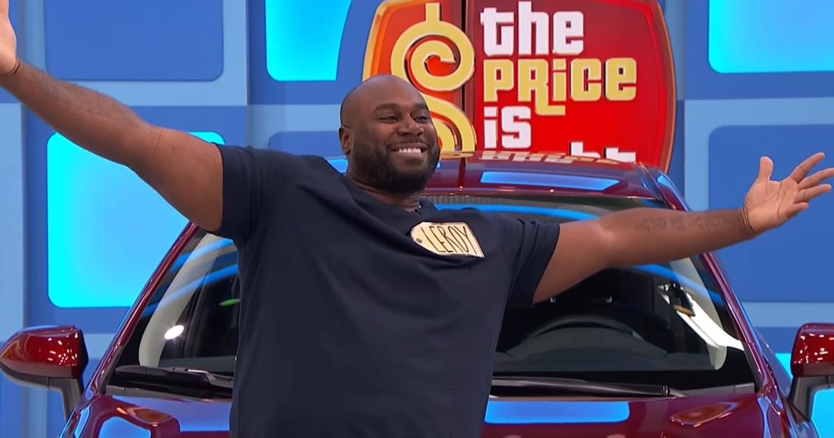 Screenshot showing the contestant, Leroy posing with his new car (Cover image source: YouTube/The Price Is Right)