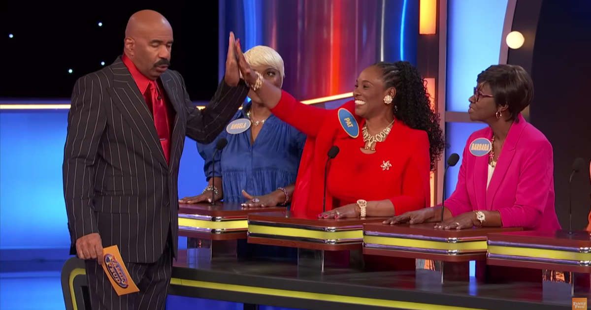 Screenshot showing the contestant high-fiving Steve Harvey on "Family Feud." (Cover Image Source: YouTube | Family Feud)