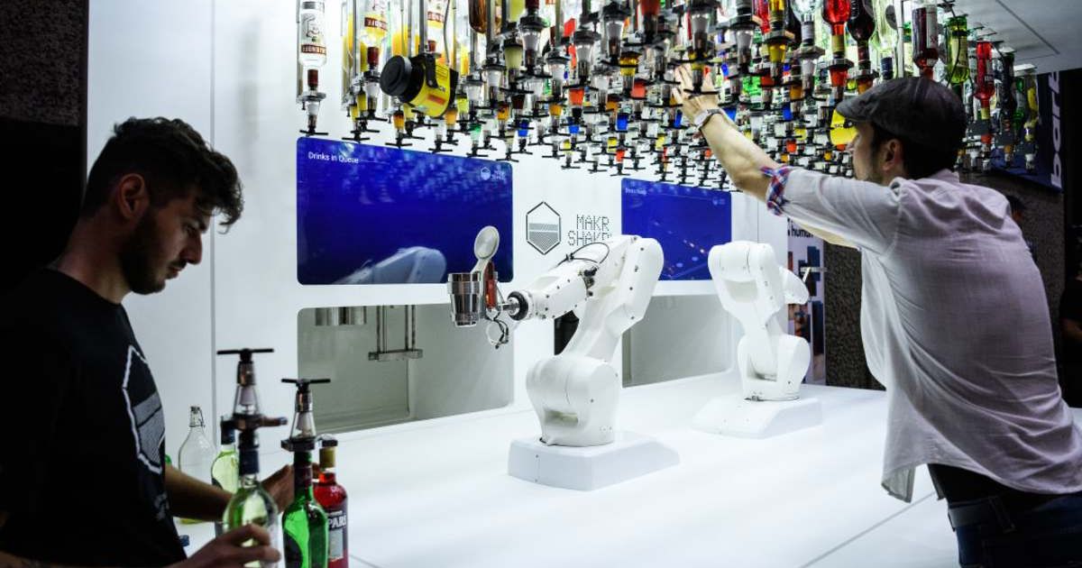 A man working with a robotic cocktail maker (Cover image source: Getty Images | Leon Neal)