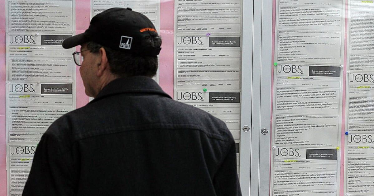 A job seeker looks at a bulletin board with job listings at the Career Link Center One Stop job center (Image Source: Getty Images | Justin Sullivan)