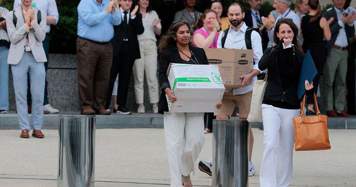 Employees walking out of the office after leaving their job. (Cover image source: Getty Images | Photo by Anna Moneymaker)