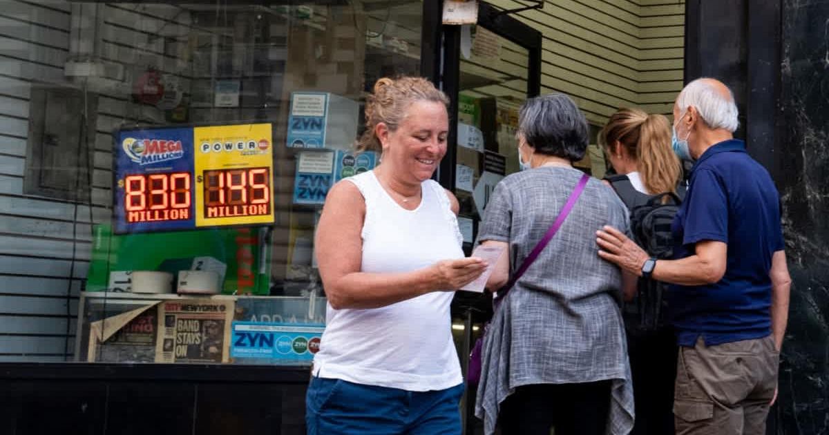 Representational picture of a woman happily looking at her lottery ticket (Cover image source: Getty Images | Alexi Rosenfeld)