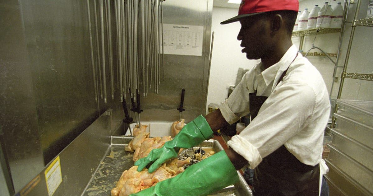 An employee preparing rotisserie chicken (Cover image source: Getty Images | Erik Freeland)