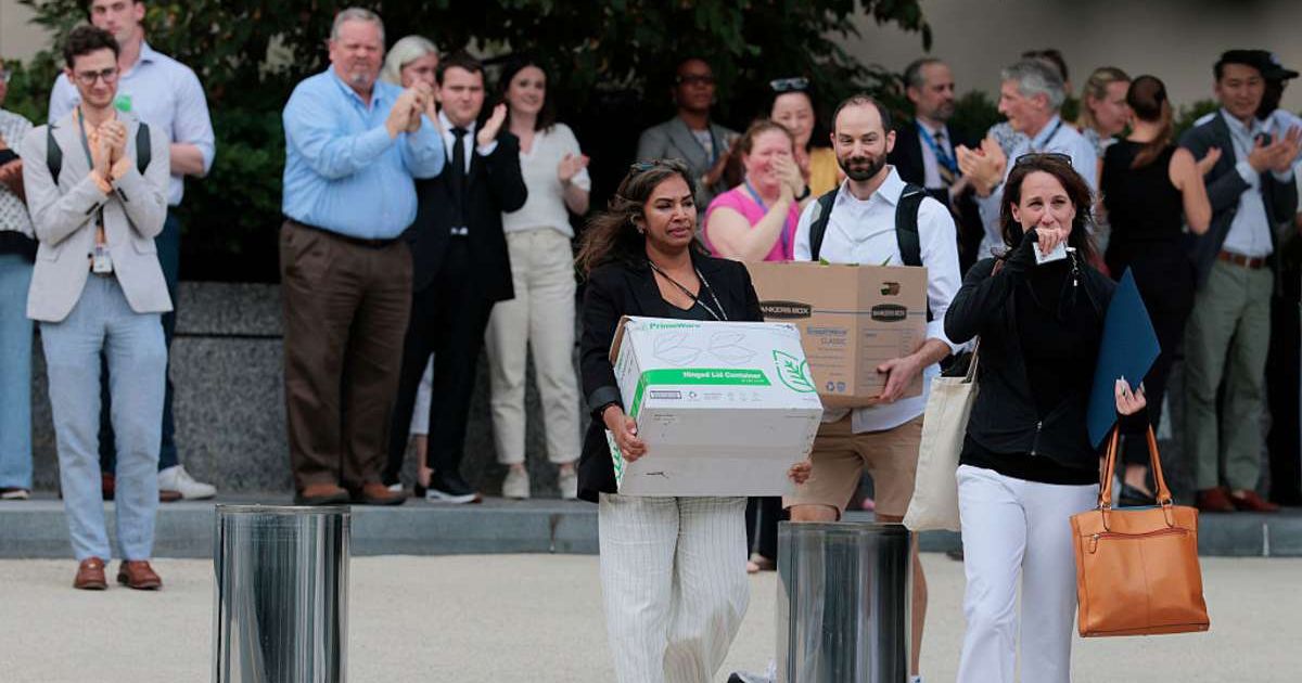 Employees walking out of the office after leaving their job (Cover image source: Getty Images | Photo by Anna Moneymaker)