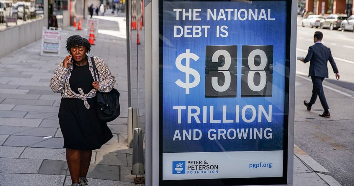 Representative image of a bus shelter where an electronic billboard and a poster display the current U.S. National debt per person and as a nation at 38 Trillion dollars on October 28, 2025 (Cover image source: Getty Images/Photo by Jemal Countess/Getty I