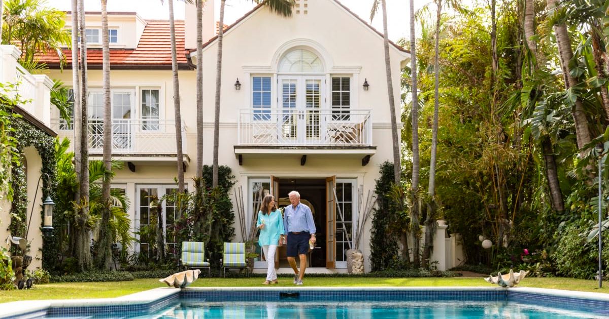 Representative image of a couple outside their Florida home (Cover image source: Getty Images/Photo by The Good Brigade)