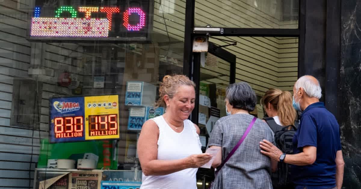 Representational picture of a woman happily looking at her lottery ticket (Cover image source: Getty Images | Alexi Rosenfeld)