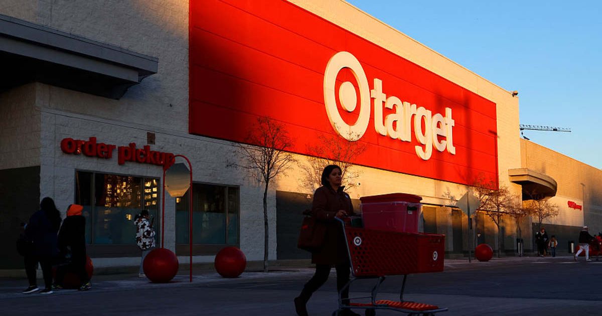 A shopper in front of a Target store. (Cover Image Source: Photo by Gary Hershorn/Getty Images)