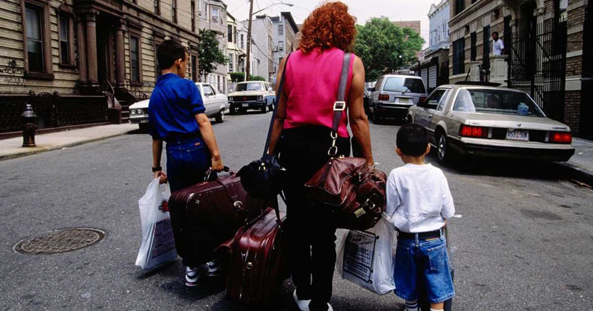 Representative image of a mother and her two sons carrying their belongings (Cover image source: Getty Images/Photo by © Viviane Moos/CORBIS)
